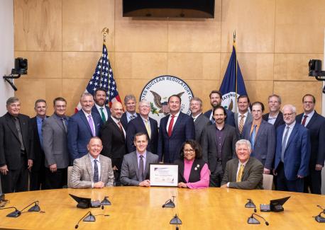 Representatives from Natura Resources, the Zachry Group, Abilene Christian University, The University of Texas at Austin, Texas A&M University, and the Georgia Institute of Technology receive the issued Construction Permit at the Nuclear Regulatory Commission. (Image credit – Natura Resources LLC)